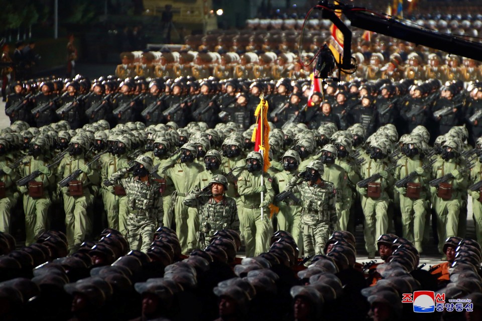 Soldiers wearing gas masks marching in the parade