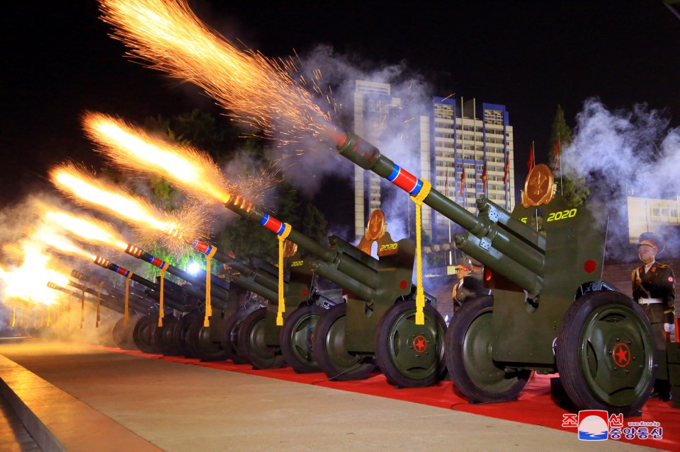 Guns firing a salute at the start of the parade