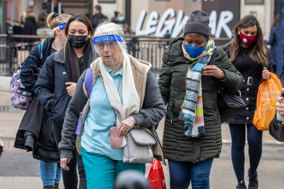 Members of the public wear masks and shields while out shopping in Oxford Street, London today