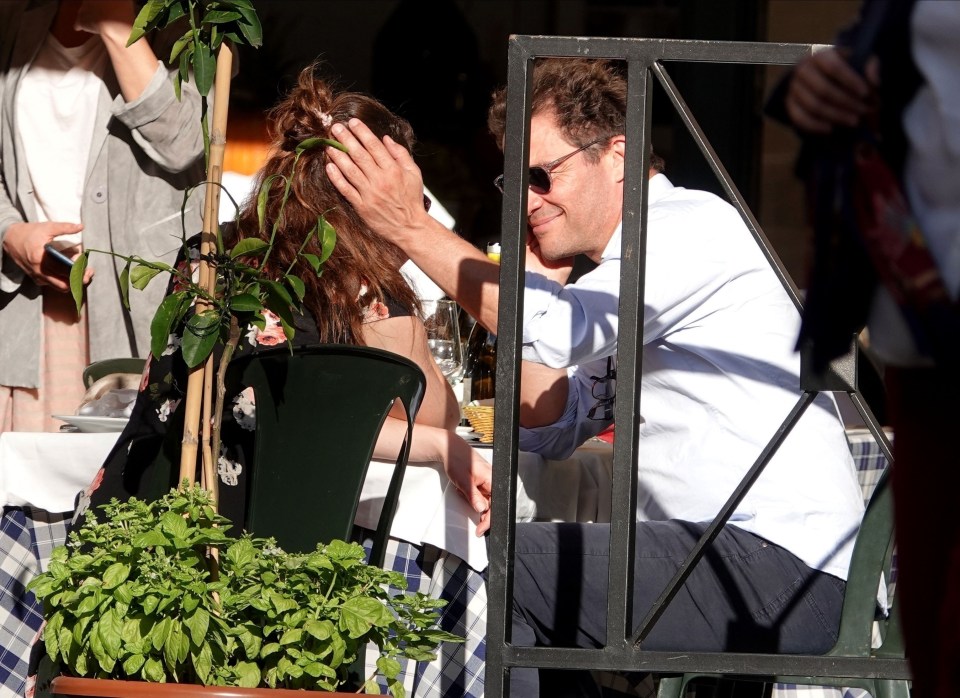 The co-stars looked affectionate as they sat in the sunshine