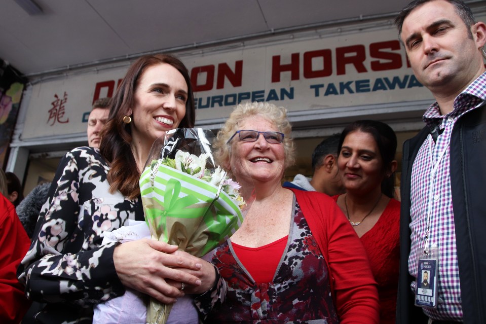 New Zealand Prime Minister Jacinda Ardern poses for a photograph with a supporter