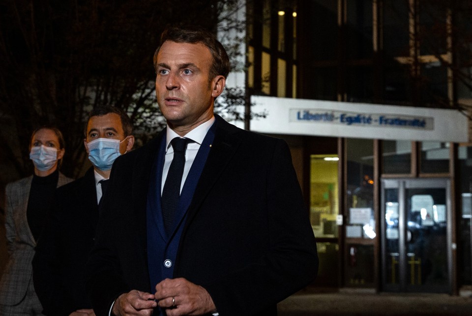 President Macron speaks outside the school in Conflans Saint-Honorine, flanked by Interior Minister Gerald Darmanin, second left