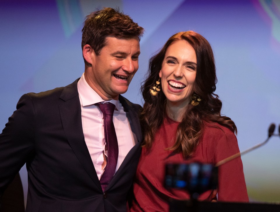 The PM smiles with partner Clarke Gayford