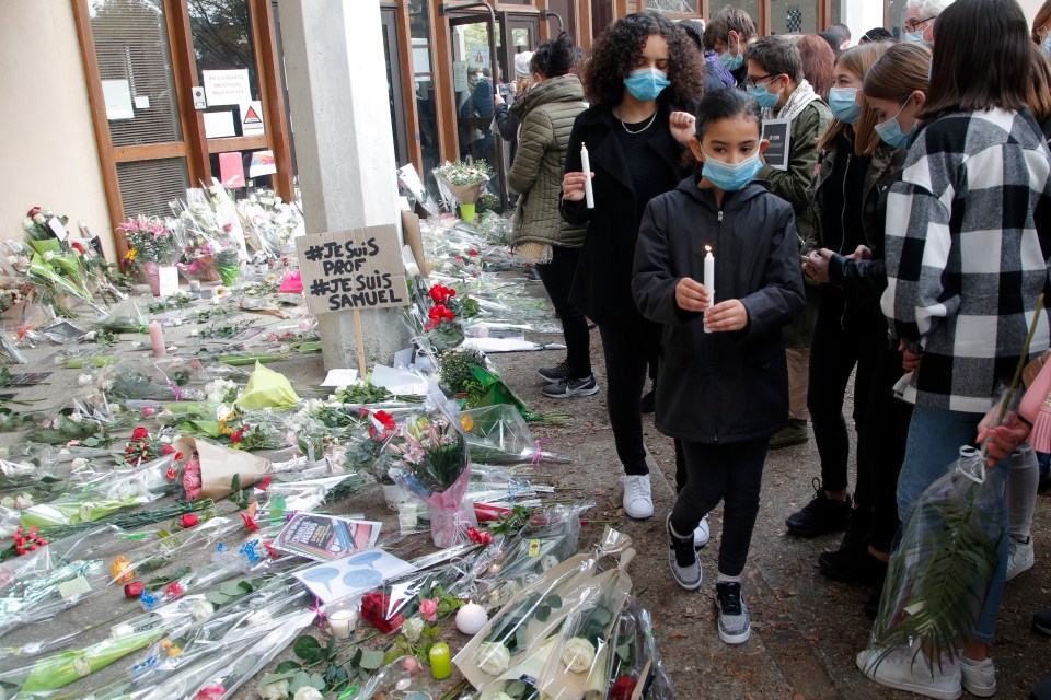 Pupils and parents laid flowers and candles to pay their respects