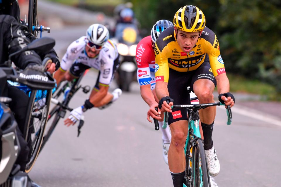 Alaphilippe misjudges the gap to the motorbike and clips the side of one