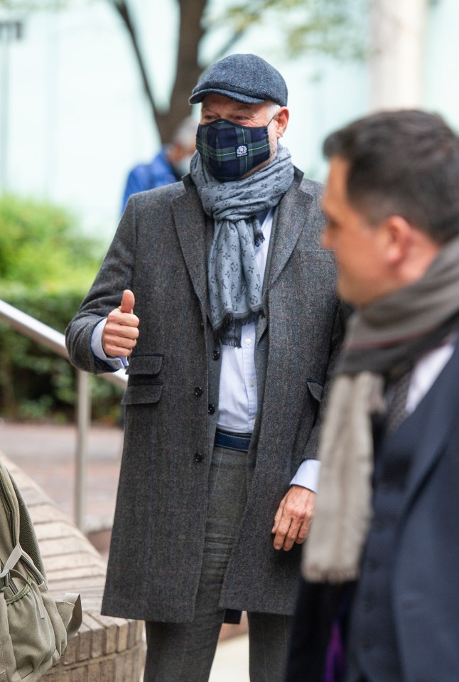 John Leslie gives the thumbs up as he leaves the court after being cleared