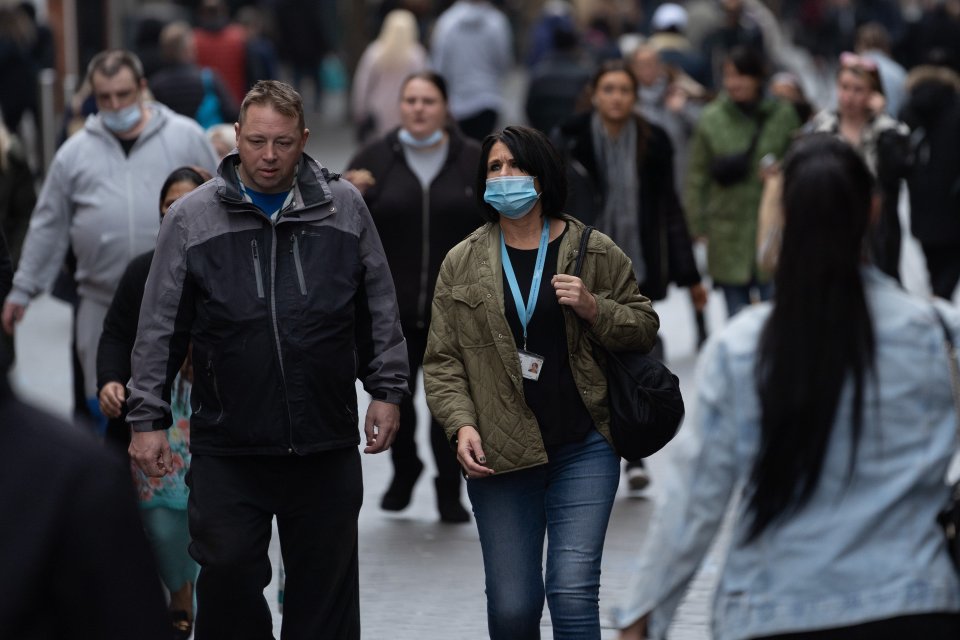 People wear masks as they walk through Nottingham city centre