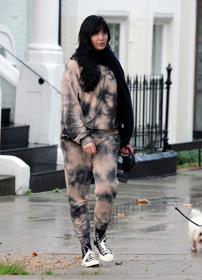 Daisy Lowe covers up in tie dye tracksuit and black scarf in Primrose Hill