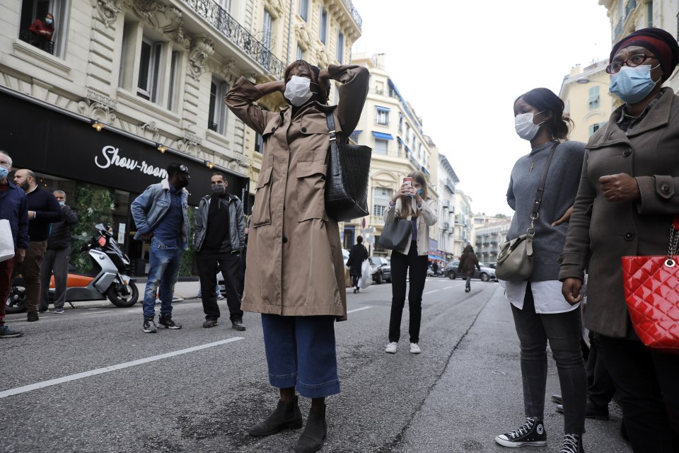 Parishioners react near the Notre Dame Basilica church in Nice