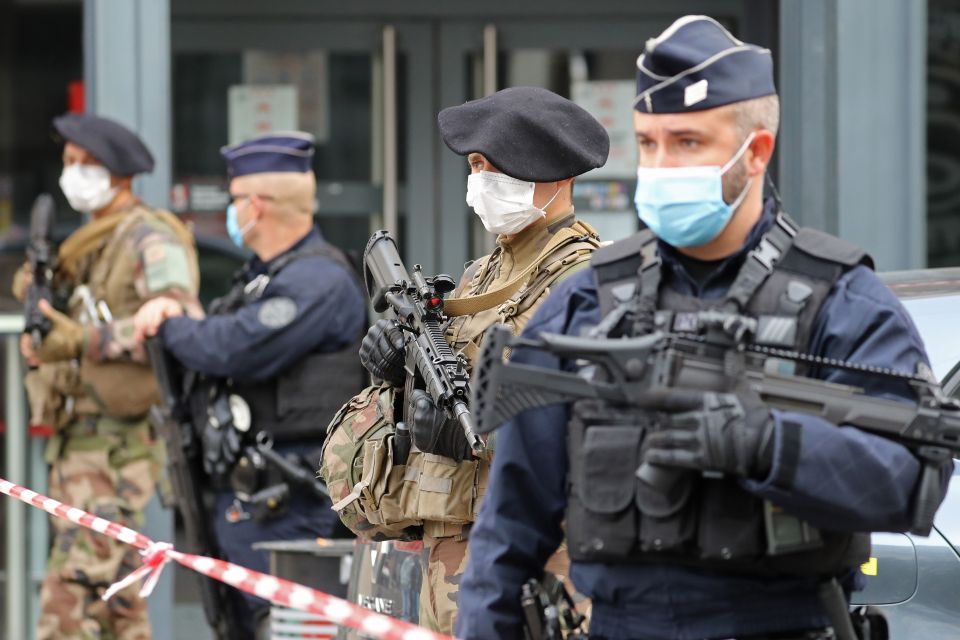 French soldiers and policemen secure the site of a knife attack in Nice