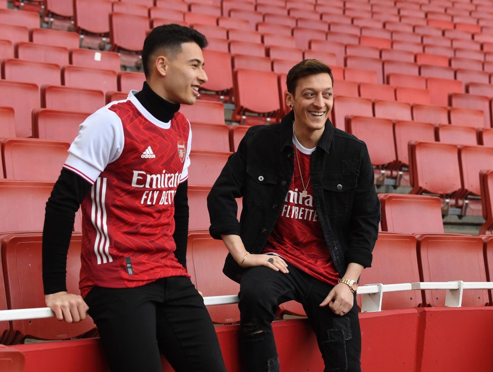 Mesut Ozil models a new Arsenal kit that he appears unlikely to play in