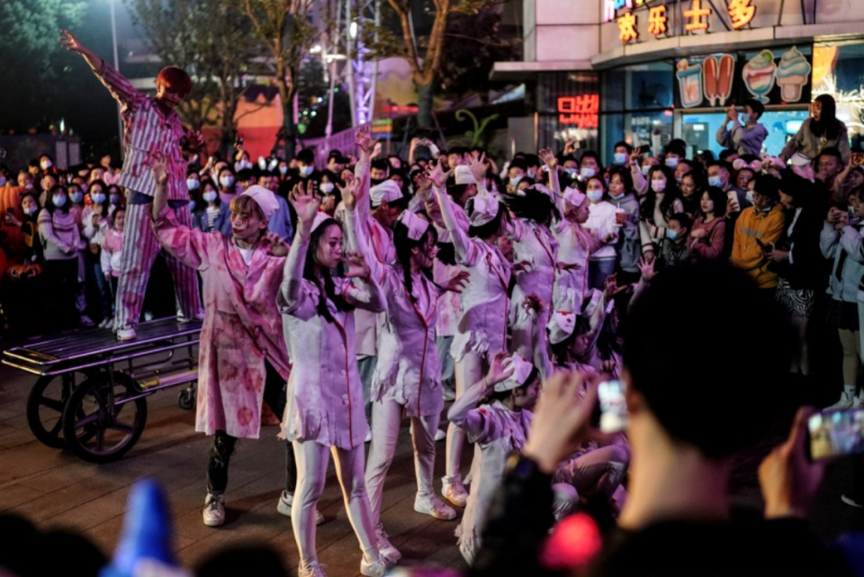 People dress as medical officials and patients as they dance to celebrate Halloween in Wuhan