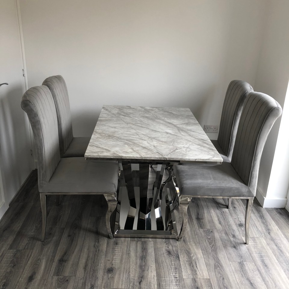 The couple has bought a marble dining table set with grey chairs for their new home