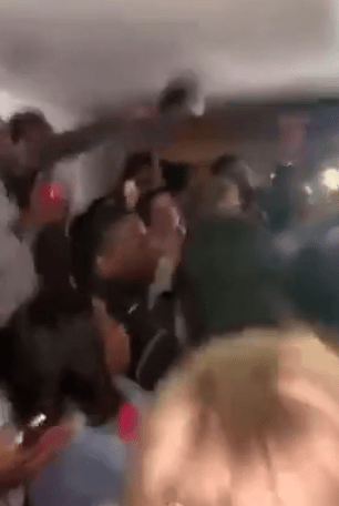 Students were filmed dancing on tables surrounded by dozens of pals