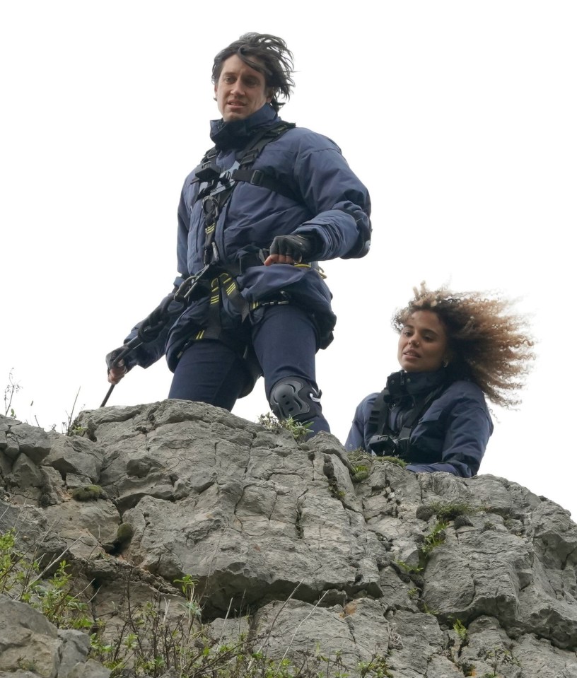 Cliff hanger! Vernon Kay and Jessica Plummer help the stars below