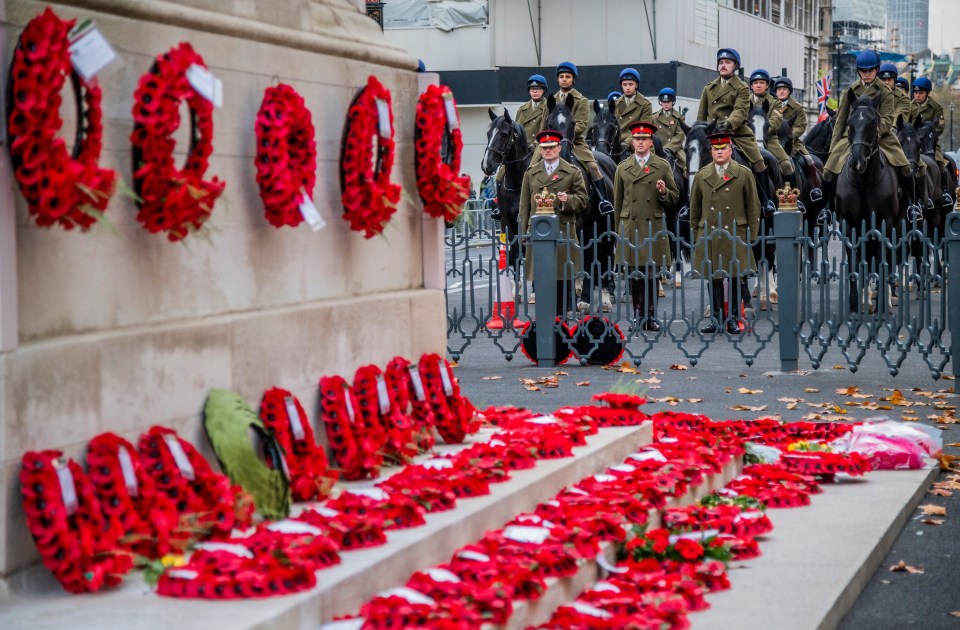 A troop of the Household Cavalry pay their respects in the early morning at The Cenotaph