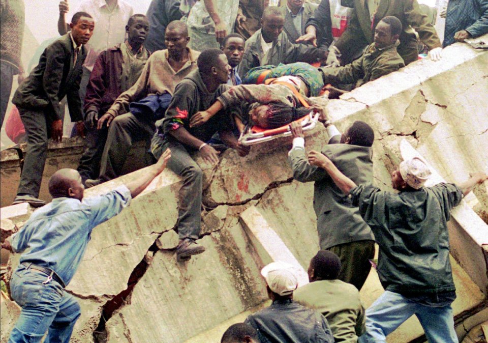 Rescuers work to help survivors amid the devastation after the bomb attack in Nairobi