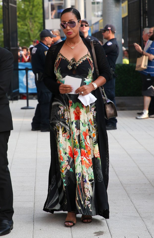 a woman in a floral dress is walking down the street