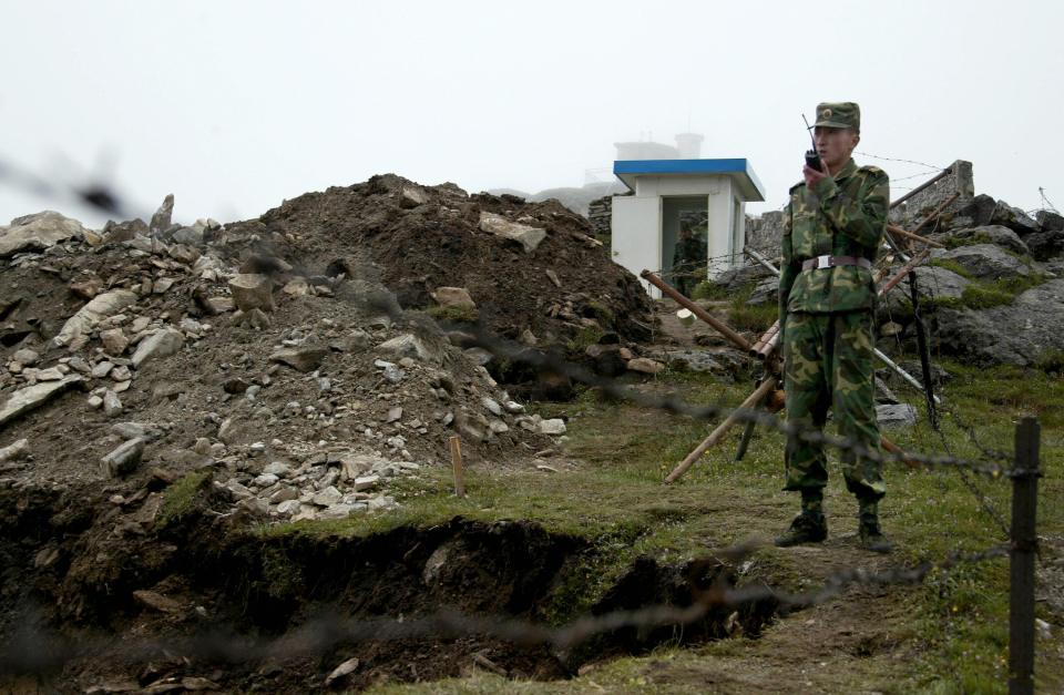 A Chinese soldier stands guard on his side of the India and China border