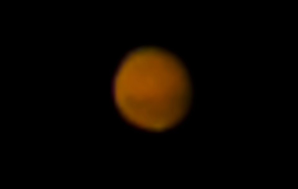 Mars in the night sky as viewed through a telescope