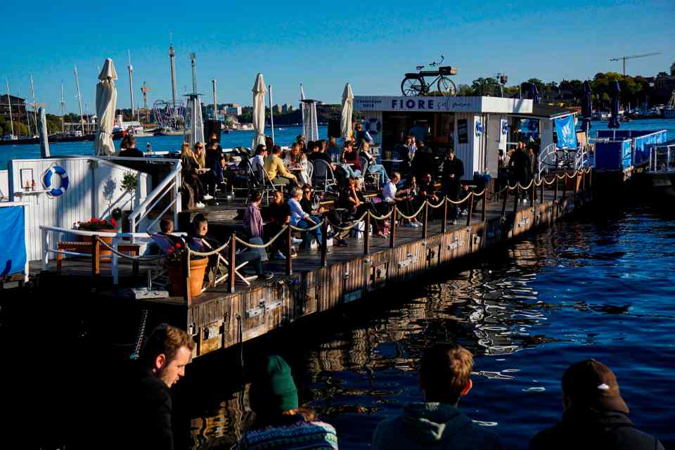 Swedes enjoying the weather on a floating bar in Stockholm 