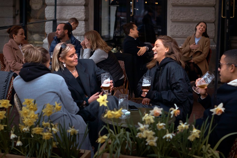 People pictured chatting and enjoying a drink in a bar in Stockholm city centre