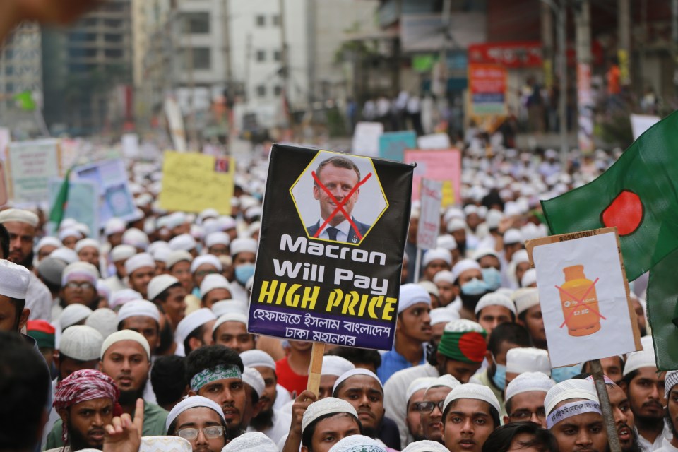 Protesters carry a sign warning Macron 'will pay a high price' 