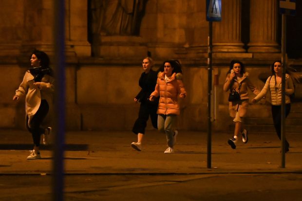 Bystanders flee as the jihadi goes on a rampage in Vienna