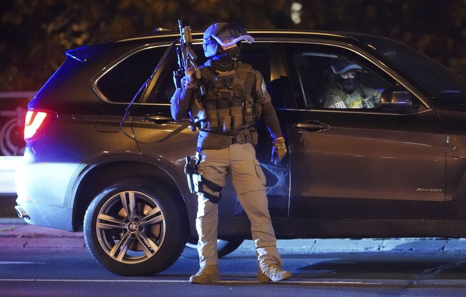 An armed cop takes to the streets of Vienna as they hunt the attackers