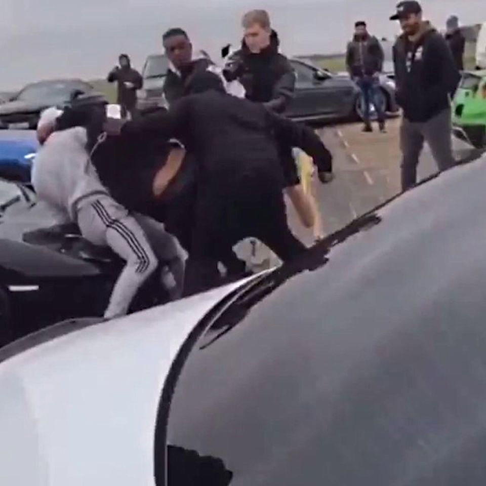 Punches were thrown as one man was sent flying into a black BMW 