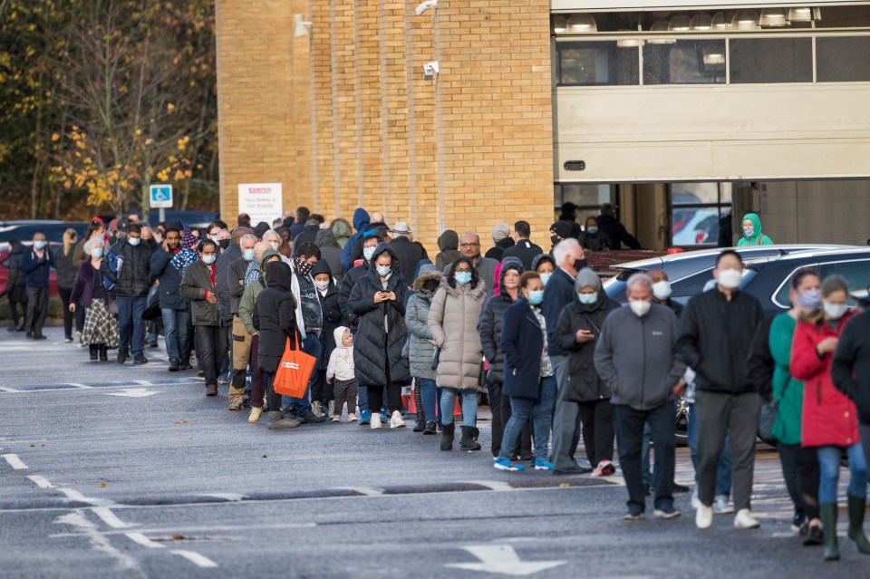 Shoppers at Costco in Watford wait patiently in a huge queue