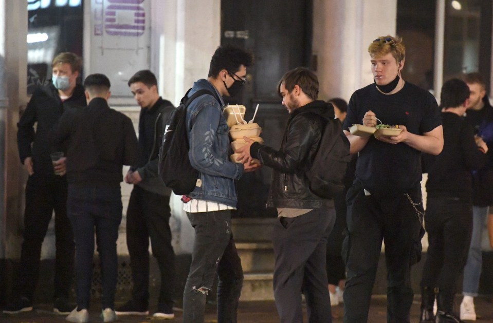 Friends share a takeaway in Portsmouth while out on the town before lockdown