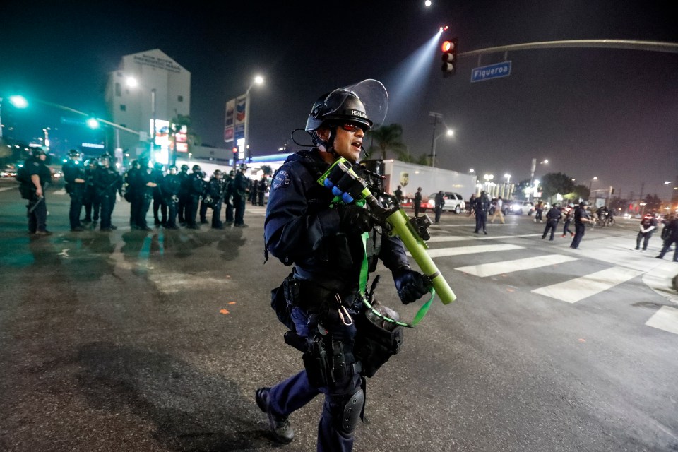 Cops in riot gear clearing the streets of LA after crowds assembled in the wake of the election