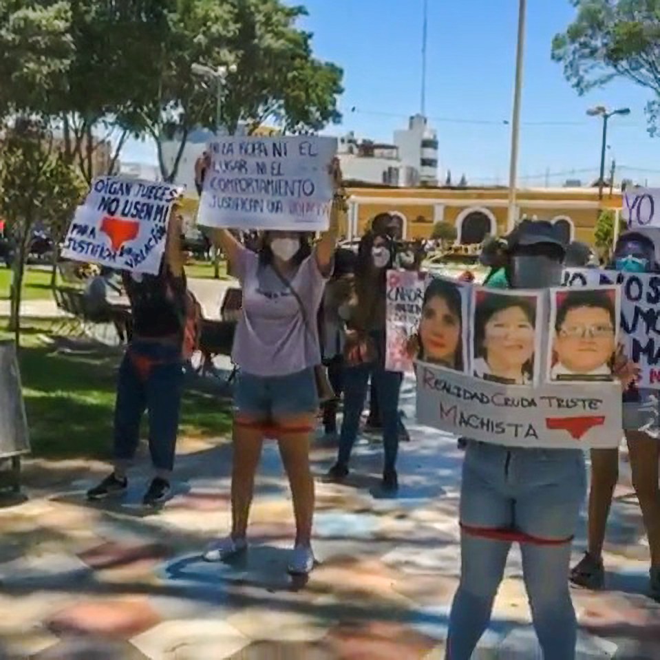 Campaigners protest on the streets of Peru, holding up placards with the judges' faces