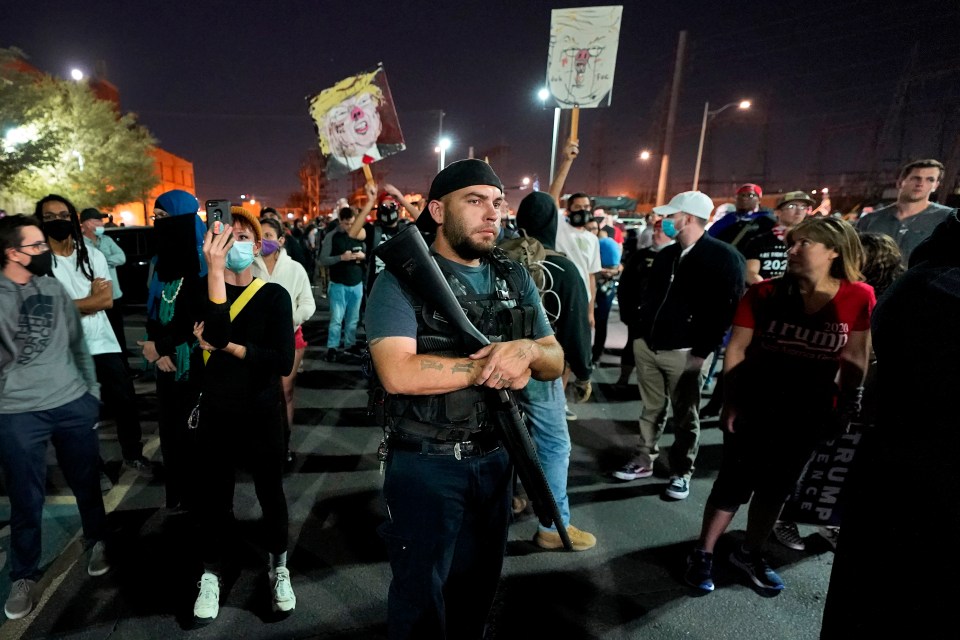 An armed Trump supporter at a demonstration in Arizona following the election