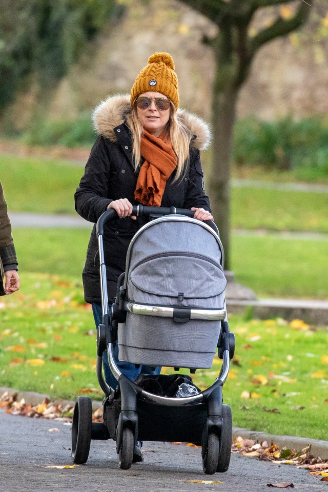 The Emmerdale star wrapped up in a black puffa coat and mustard coloured hat 