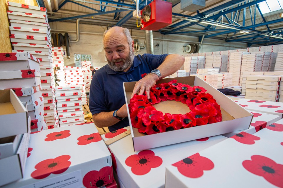 A worker packs and inspects wreaths for dispatch at the Lady Haig Poppy Factory at Redford Barracks in Edinburgh, Scotland.