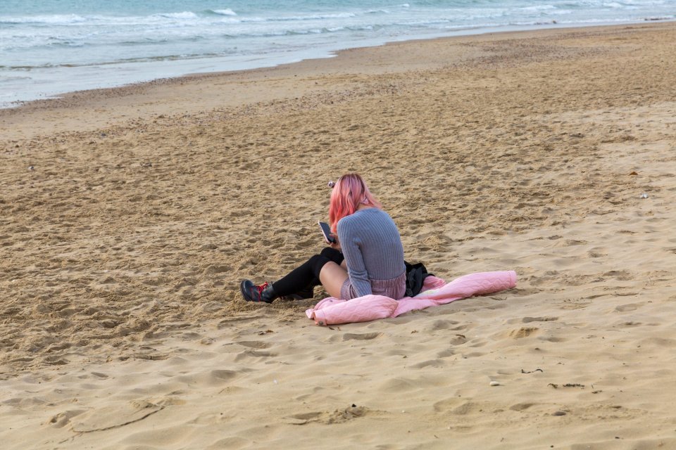 A woman is seen enjoying the waves at Bournemouth beach