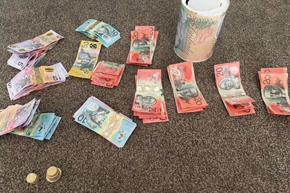 The mum, from Australia, showed off the cash in the tin after she finally opened it 