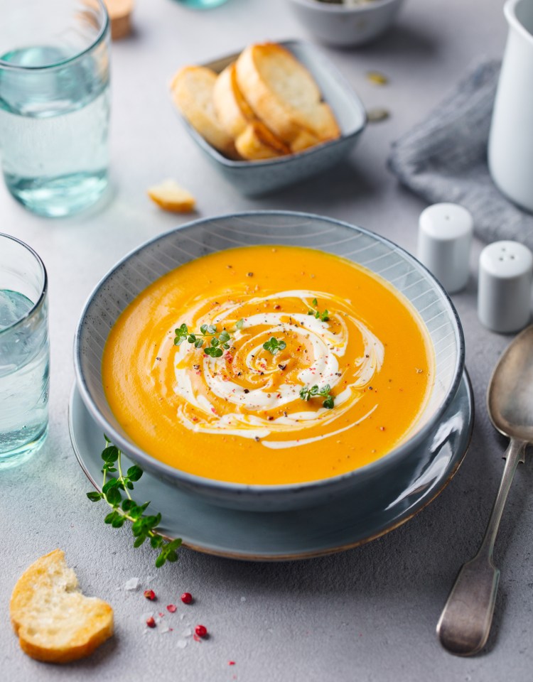 Whizz up the soup with a handheld blender, season with salt and pepper and garnish with coriander