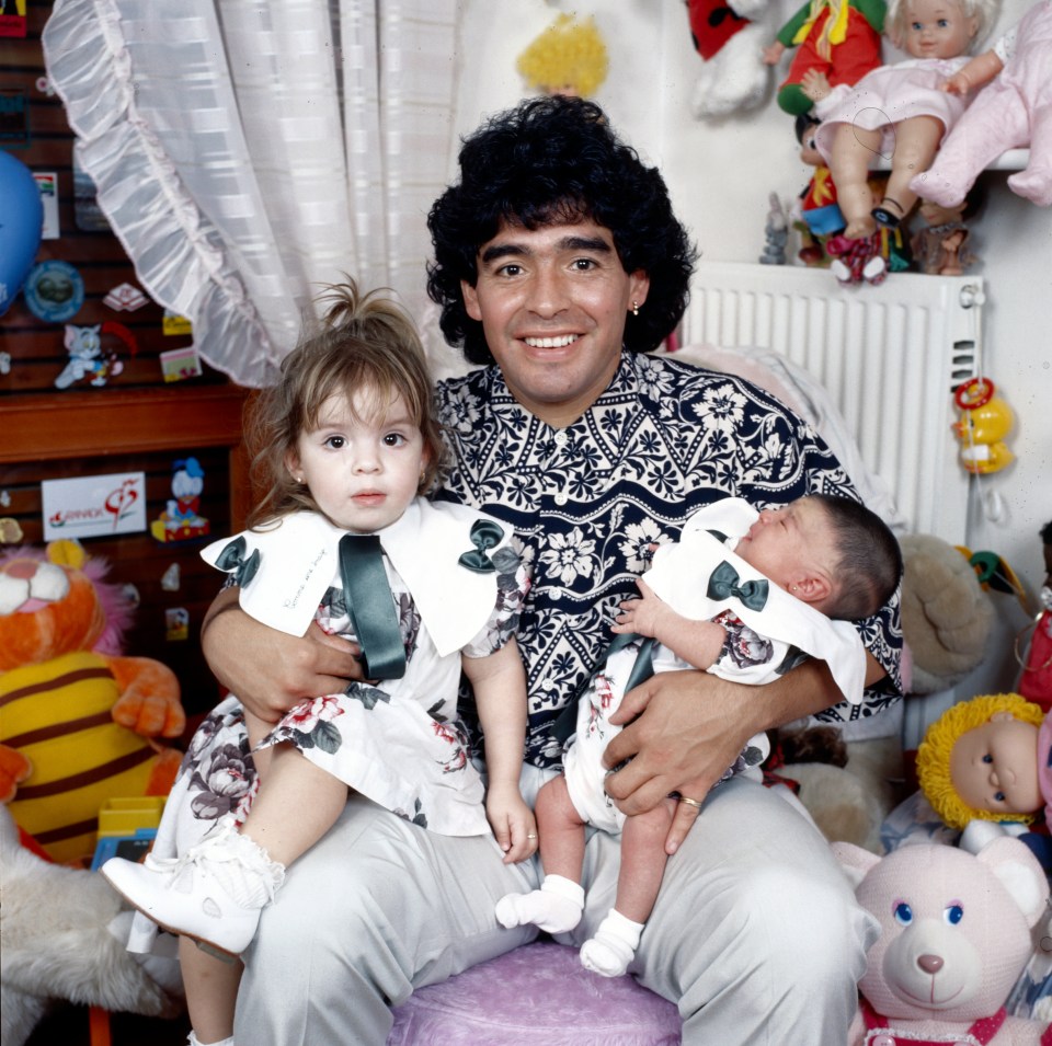 Maradona beams with with his daughters Dalma and Giannina in his arms in 1989 in Italy