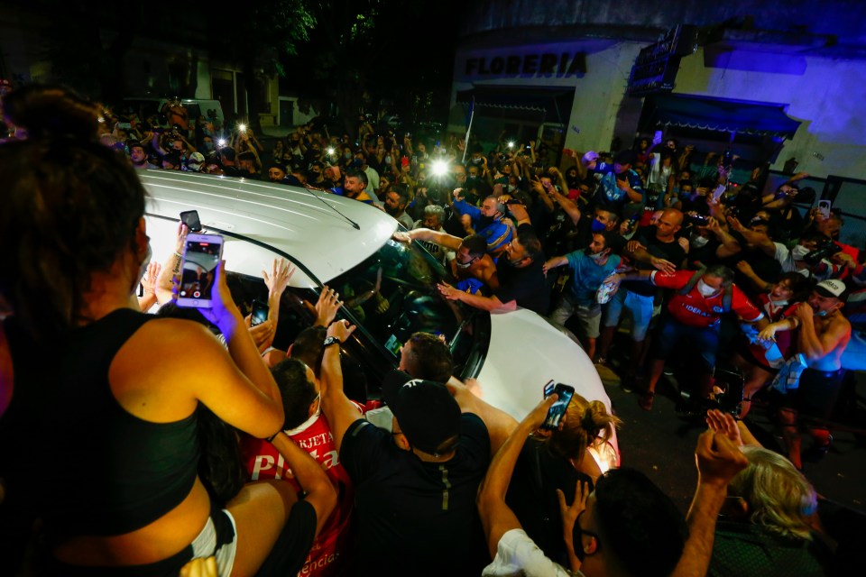 Fans surround the hearse carrying the coffin of Diego Maradona to a funeral house in Buenos Aires