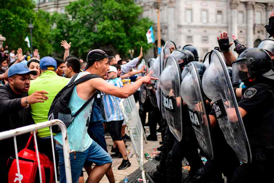 Fans break through metal barriers and brawl with riot police near the presidential palace in Argentina 