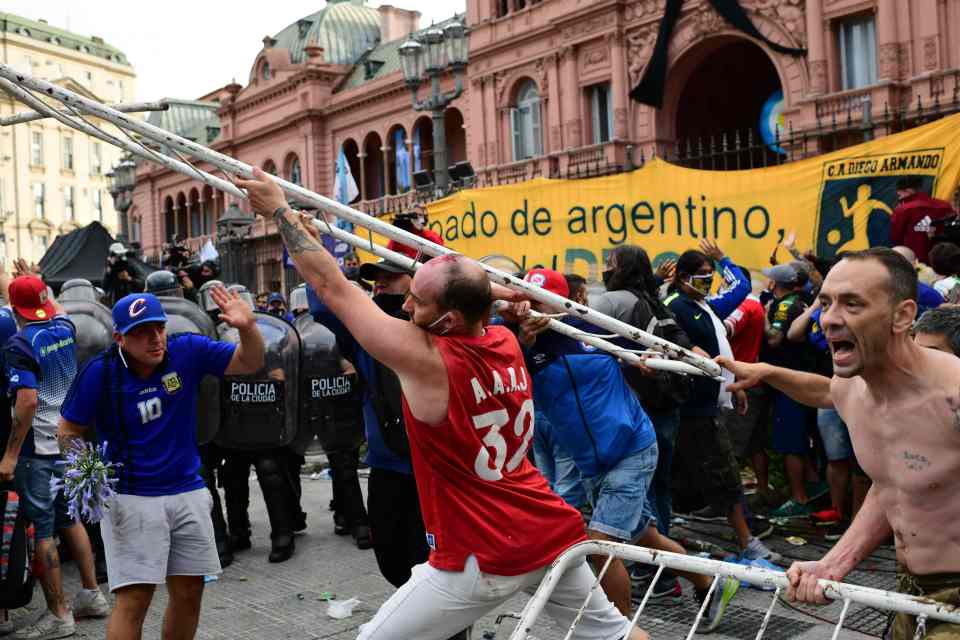 Barriers are torn down and hurled towards cops 