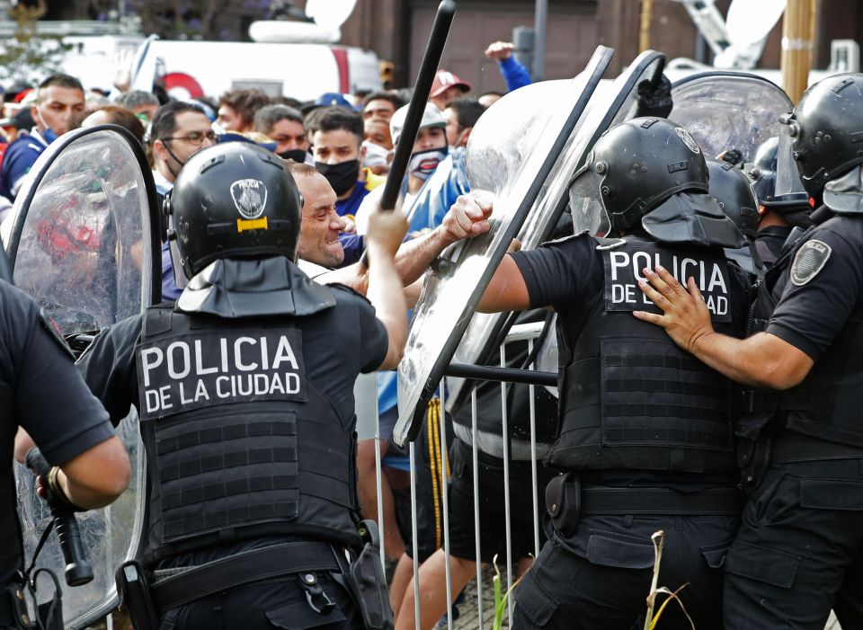 Fists and batons fly while fans fight with riot police