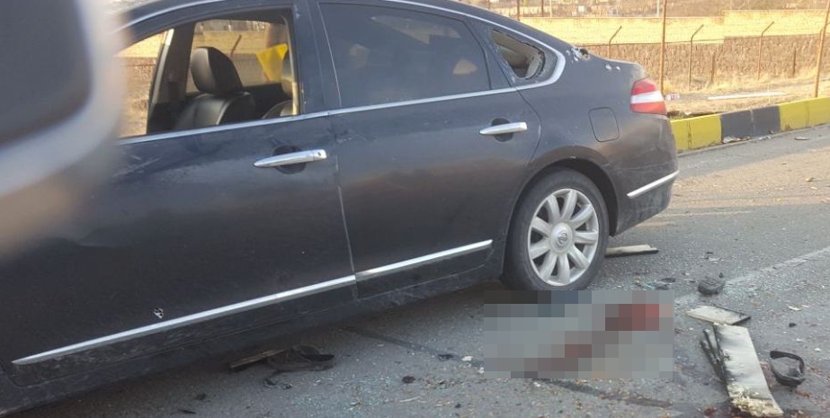 Pictures said to be from the scene show blood-soaked road and bullet holes in the car