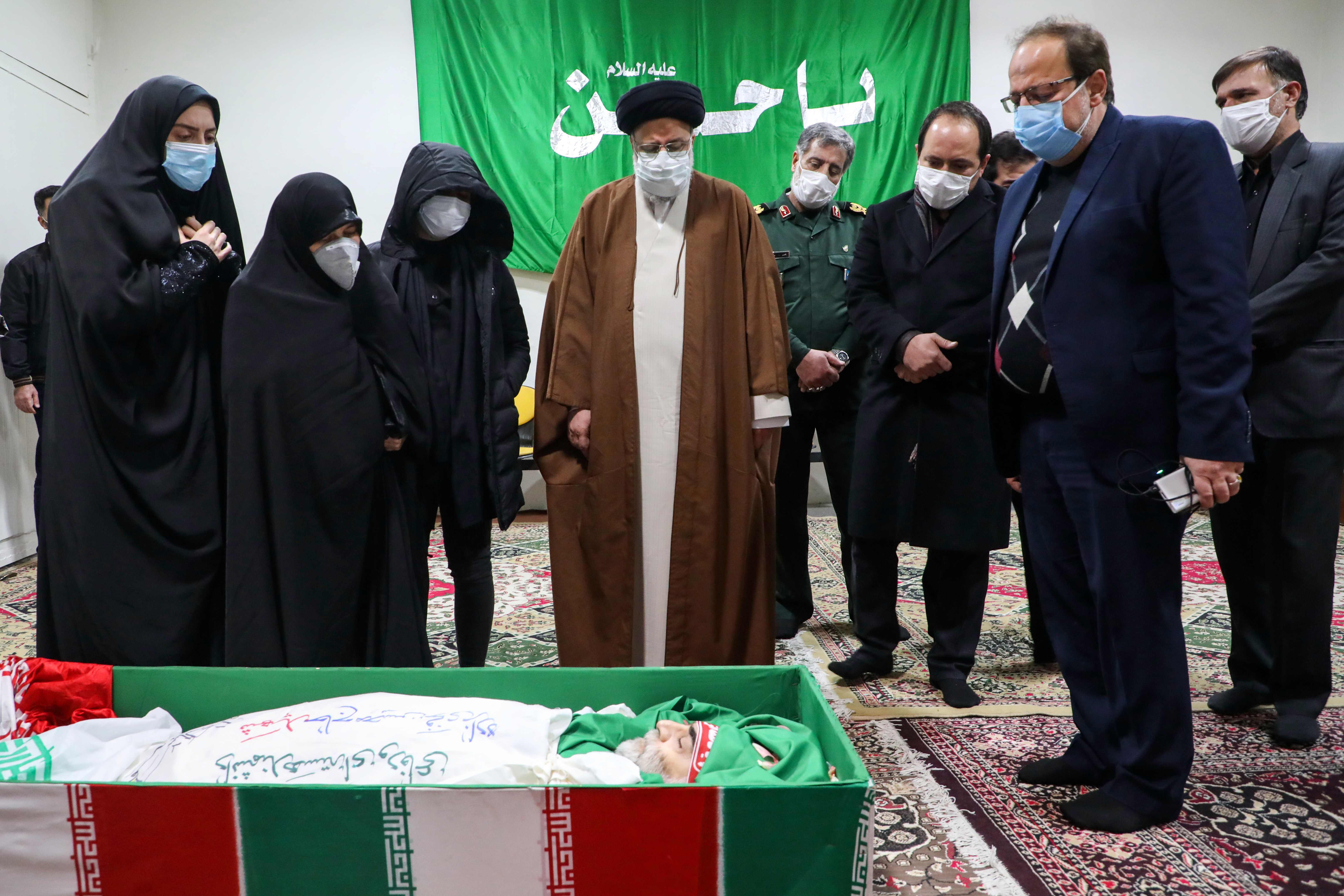 Iran's Judiciary Chief Ayatollah Ebrahim Raisi (centre) pays respects to the body of slain scientist Mohsen Fakhrizadeh 