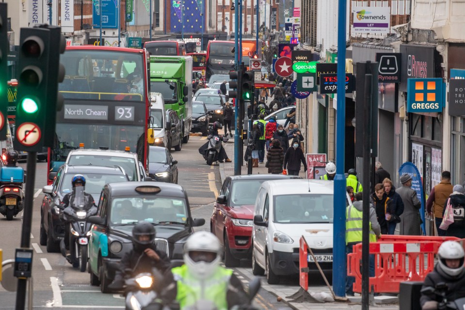 Heavy traffic as Christmas shoppers hit the stores in Putney High Street, London