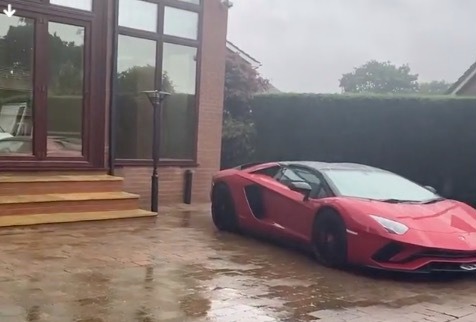 Parked on the drive is this Lamborghini Aventador – starting price £271,000