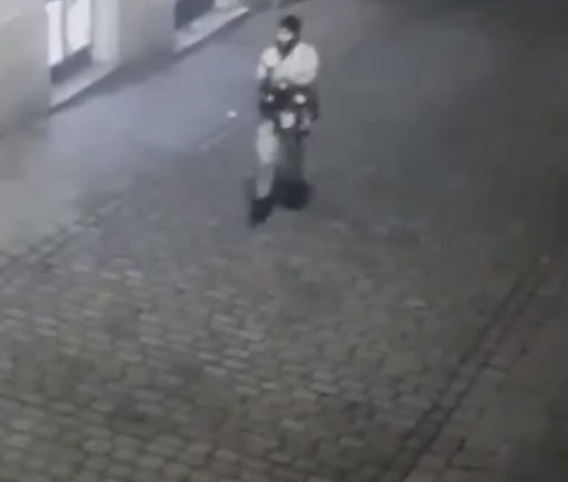 One of the terrorists cradles his weapon as he prowls through Vienna